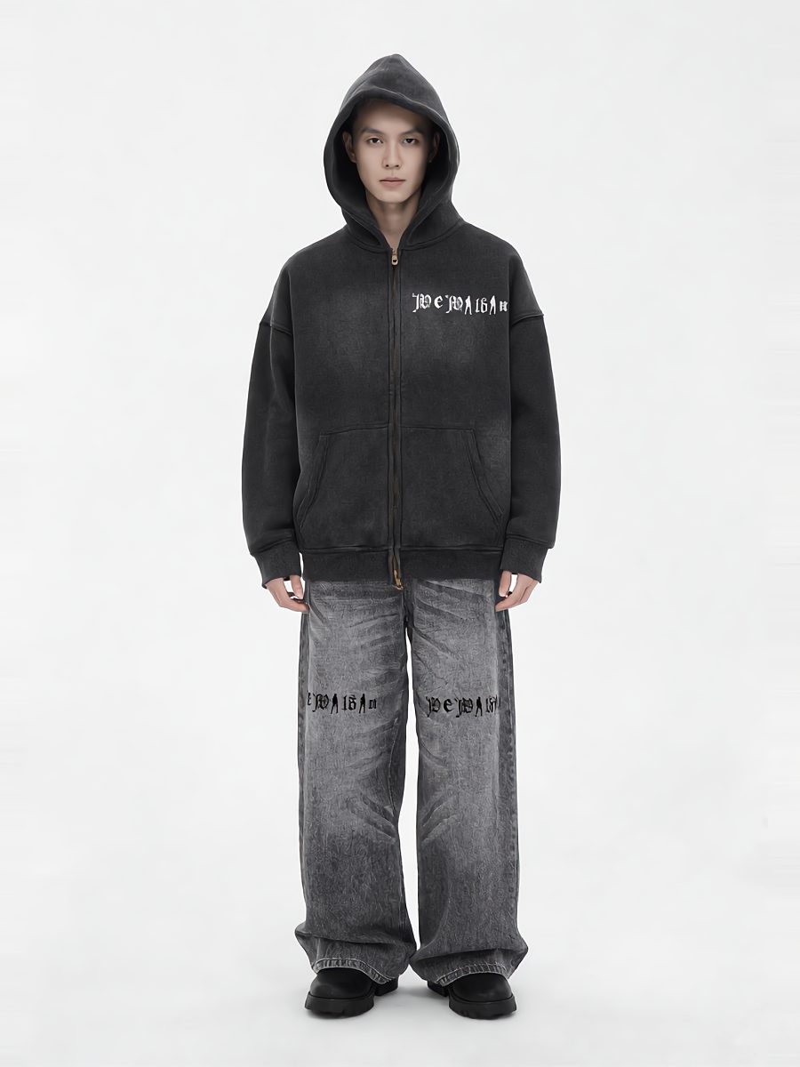 Model in a black hooded zip-up and grey wide-leg denim, full length