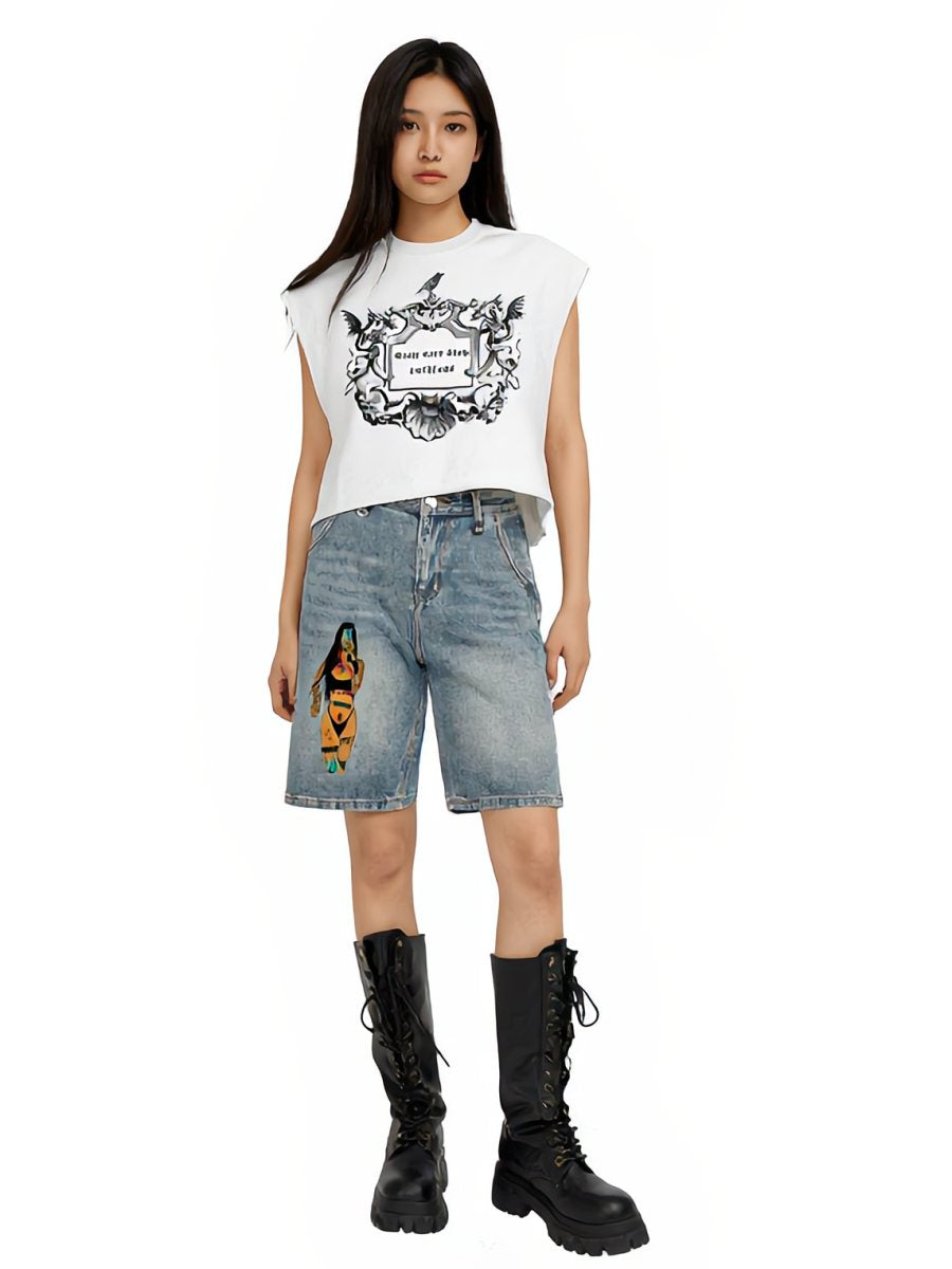 Model in the cropped crest tank, graphic denim shorts and combat boots