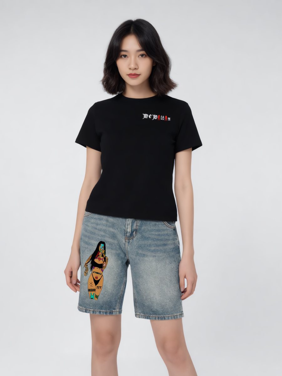Model in a fitted black We Wildin tee with graphic denim shorts
