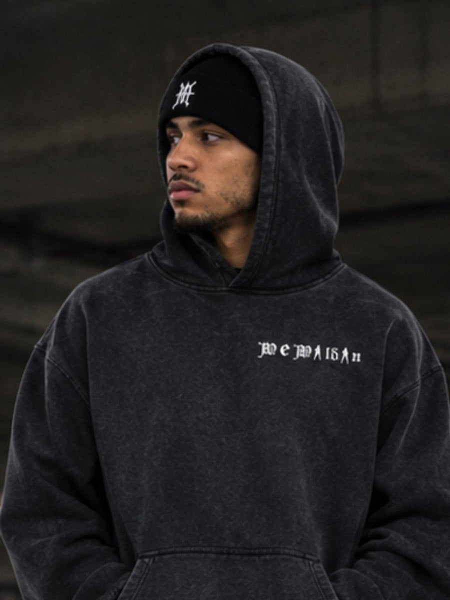 Model in the black We Wildin heavyweight hoodie, beanie and cargo jeans
